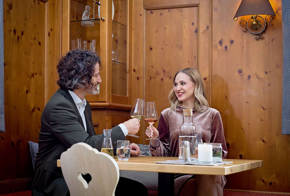 Couple toasting with wine glasses in a restaurant
