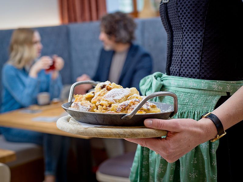Kellnerin serviert Kaiserschmarrn für Pärchen im Restaurant des Euler Landgasthofs