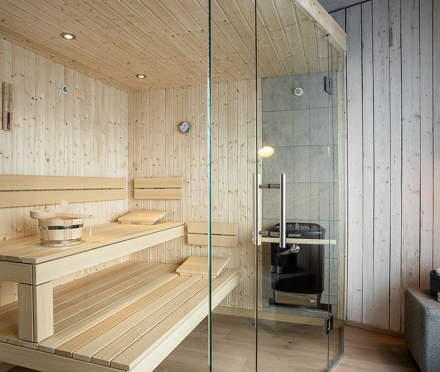 Bright wooden sauna with glass front and sauna bench